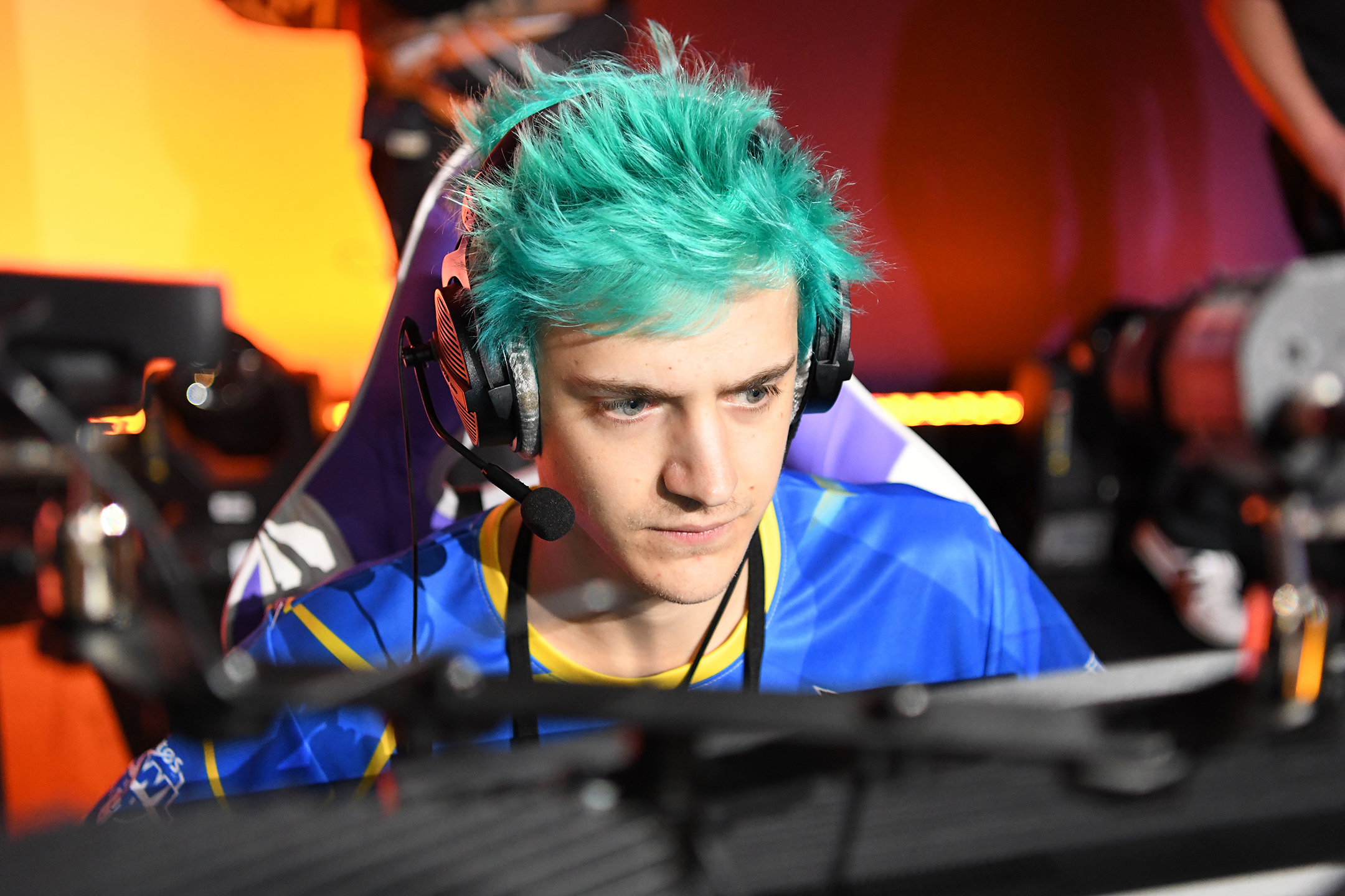 The professional gamer Tyler "Ninja" Blevins sits at a computer as he plays a game in competition