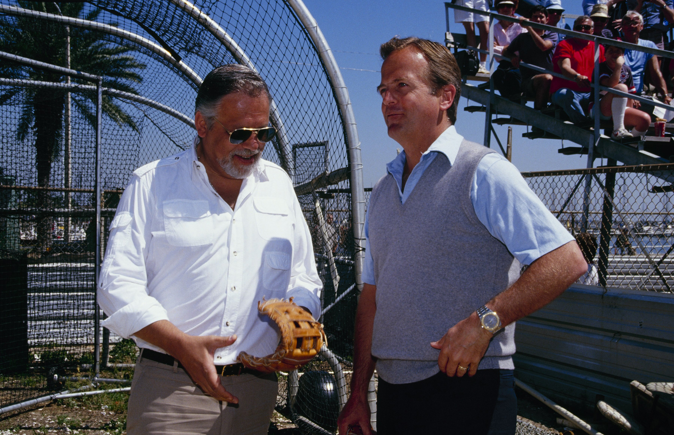  A. Bartlett Giamatti wearing a white shirt and aviator sunglasses stands next to then-MLB Commissioner Peter Ueberroth