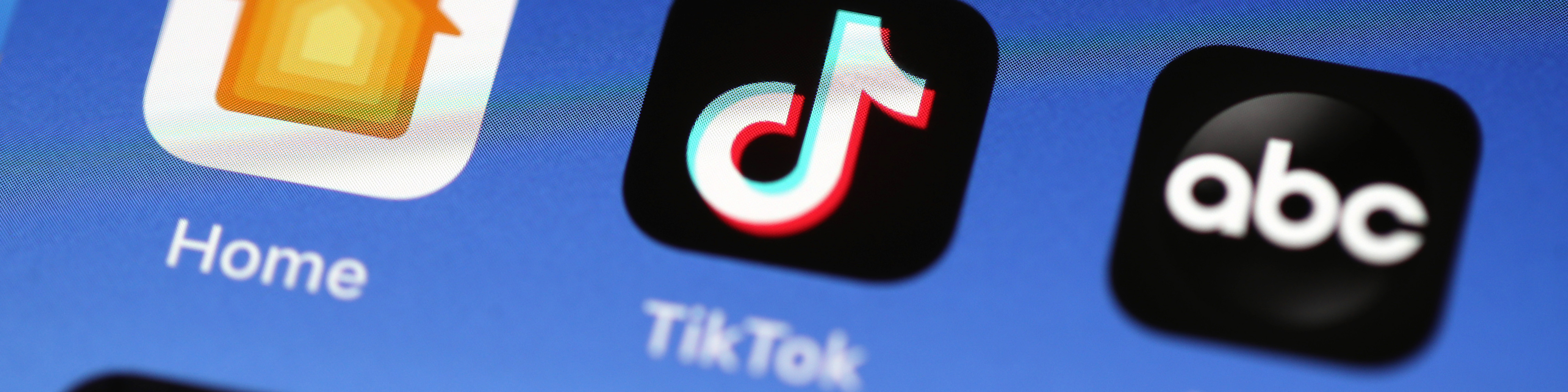 photo illustration showing the TikTok app is displayed on an Apple iPhone 