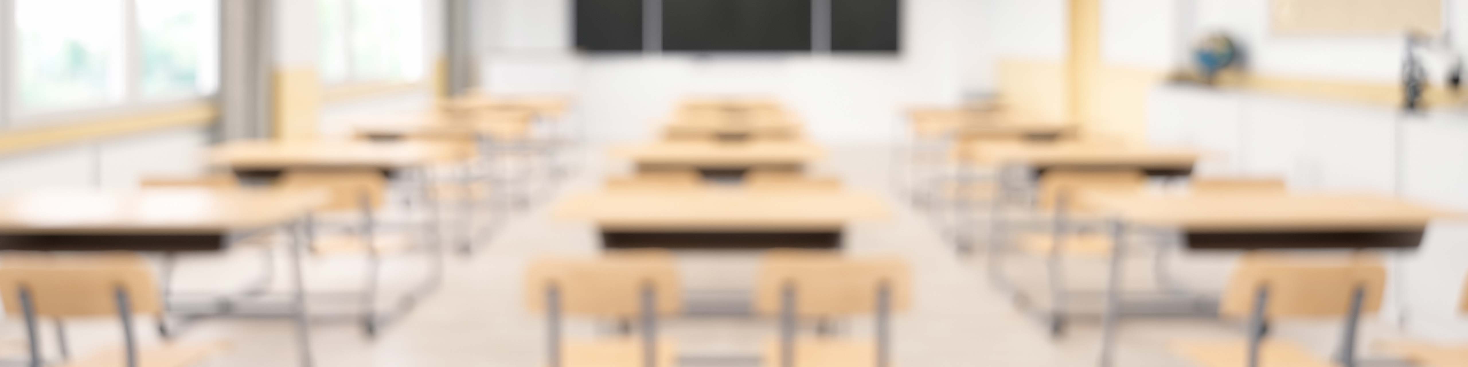 An out of focus image of an empty classroom