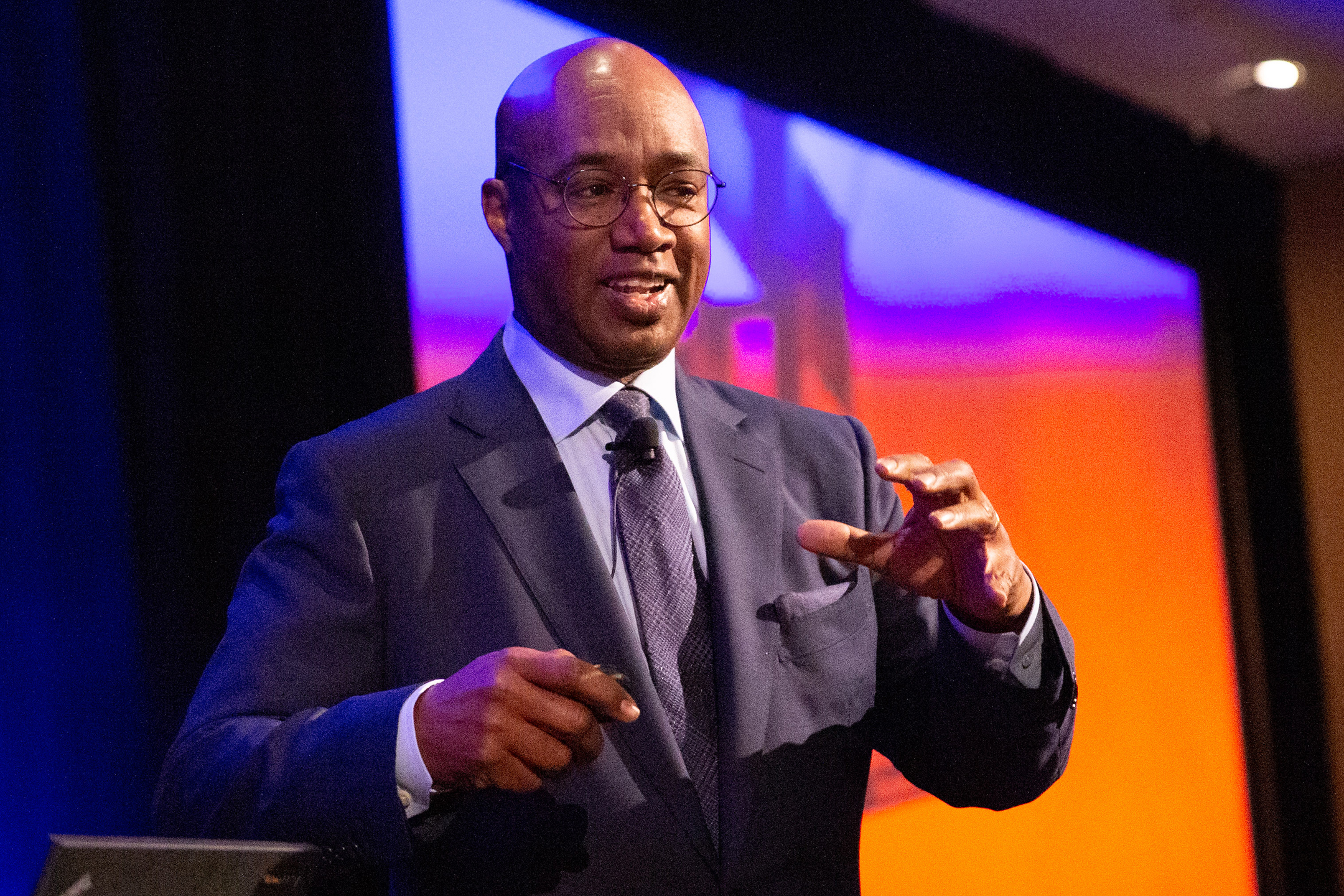 larry irving motions while giving a speech