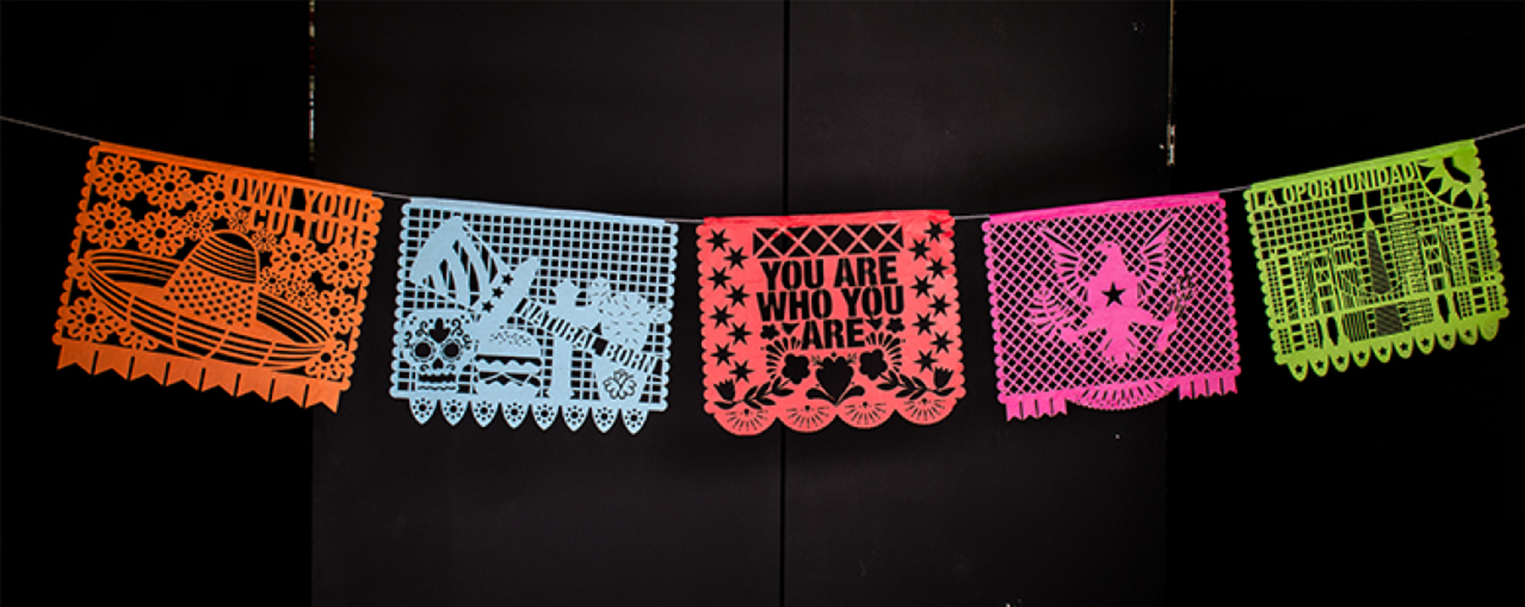 a photo of five colorful traditional mexican paper decorations against a black background