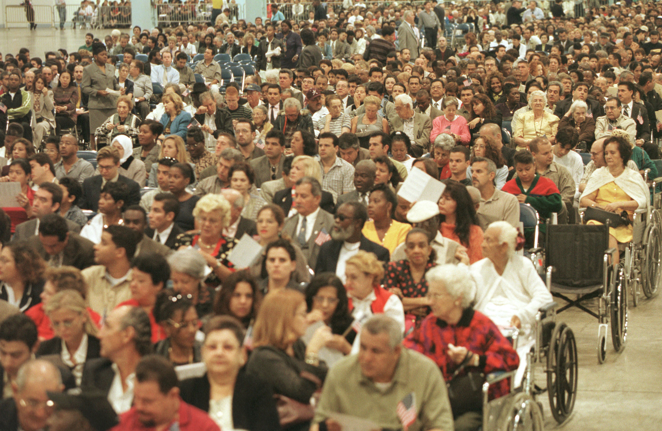 a crowd of immigrants in a large room