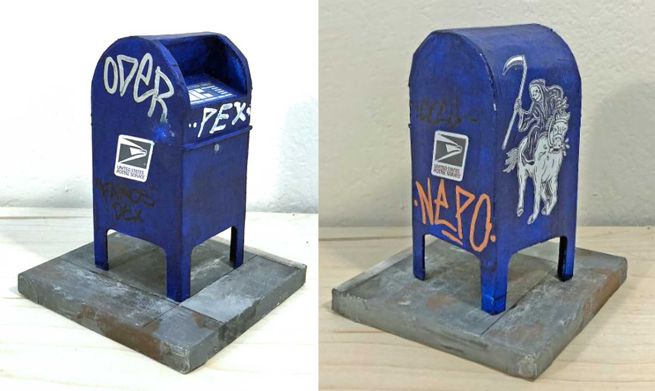 A miniature reproduction of a blue United States postal service mailbox