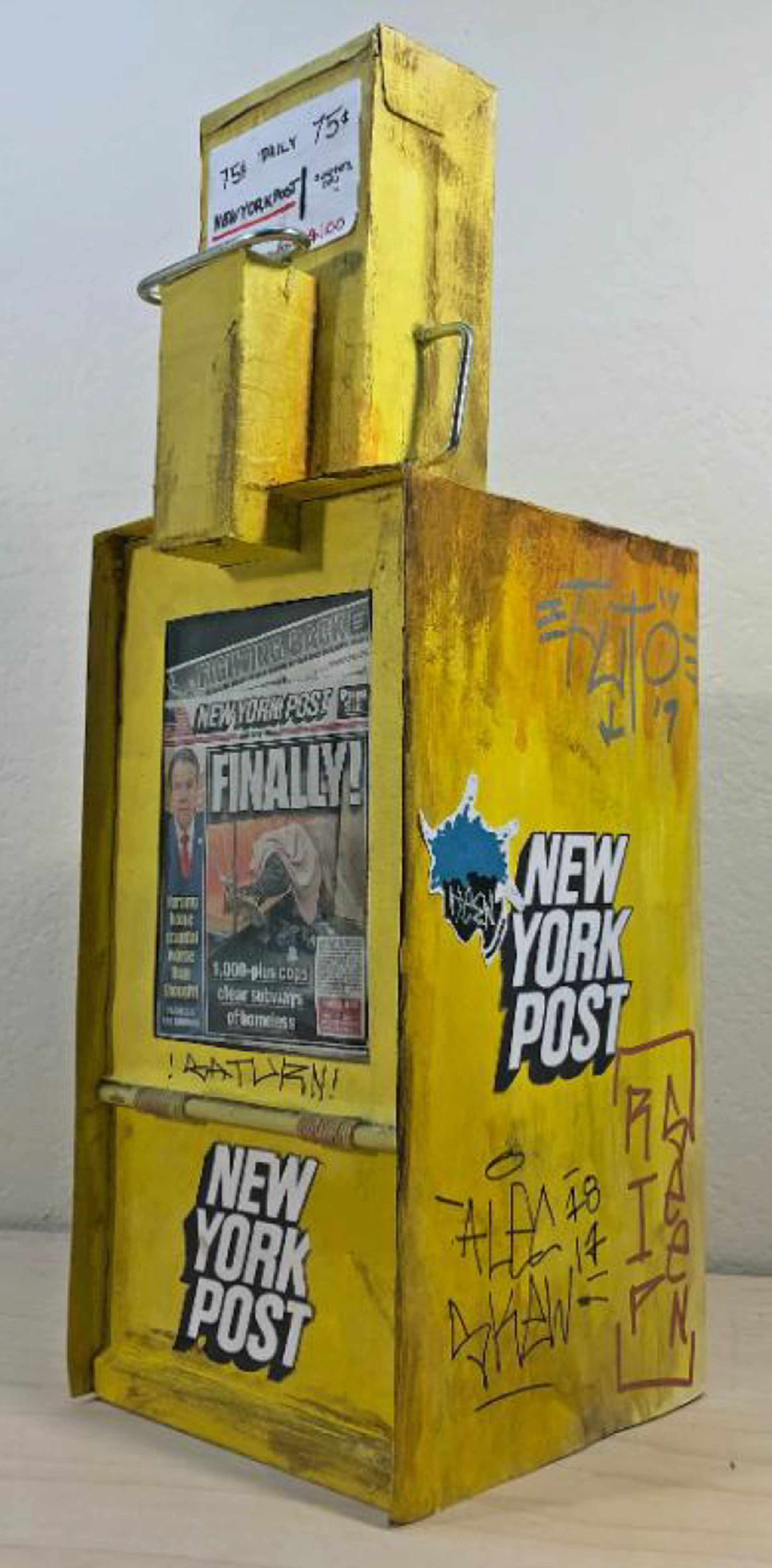 A miniature reproduction of a beat up yellow New York post newspaper box 