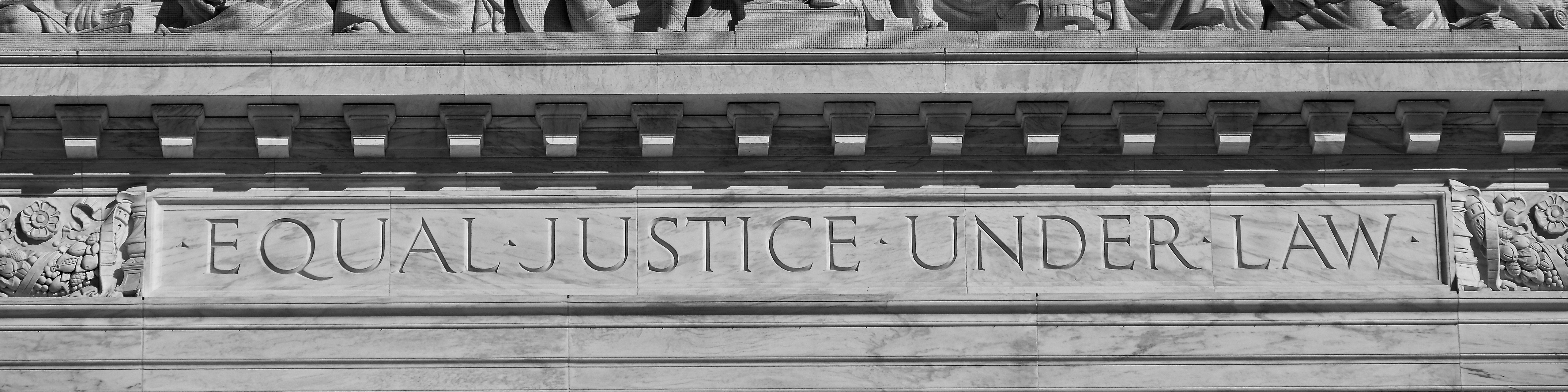 Photograph of the top of the Supreme Court building with the words Equal Justice Under Law etched into the facade 