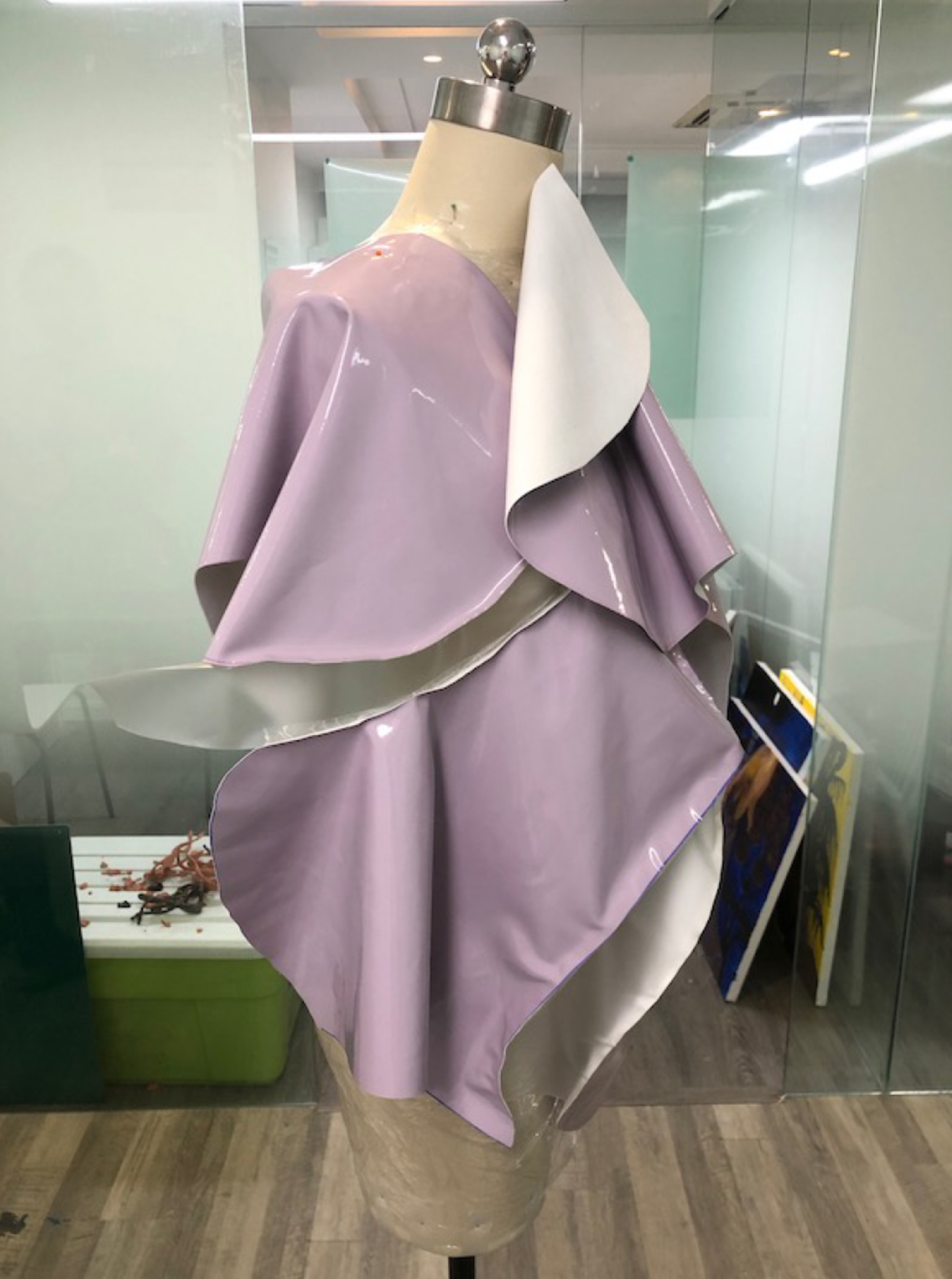 Photo of a pink dress, rather shapeless, made from a vinyl-like material