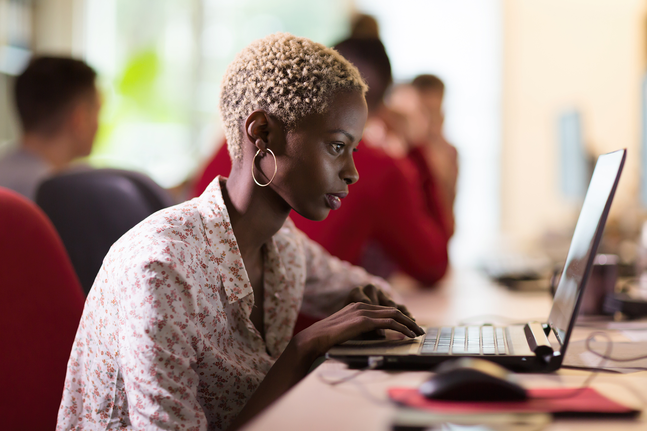 Young black woman with short hair working on a computer