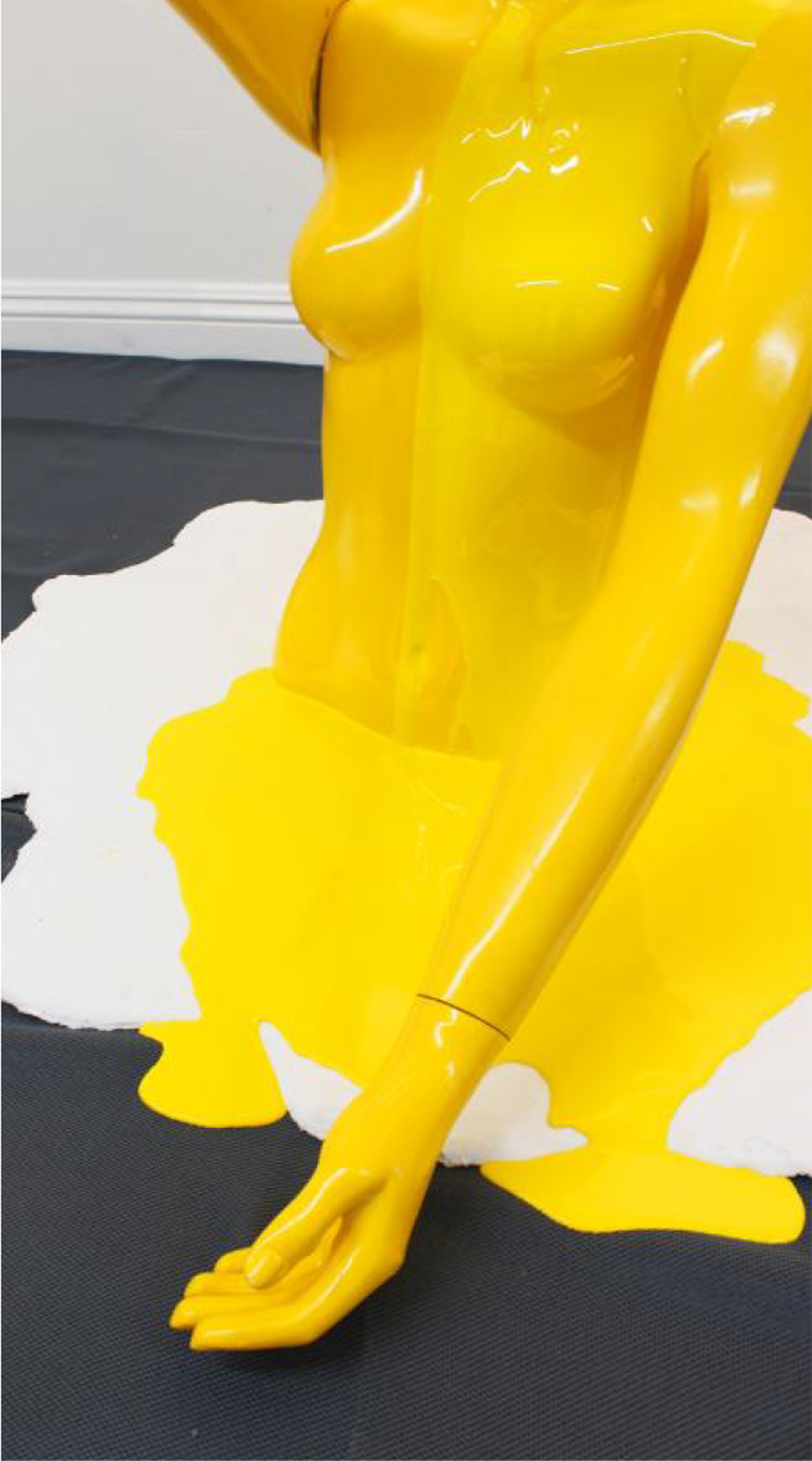 Photo of a mannequin torso painted yellowfins on top of a white mat