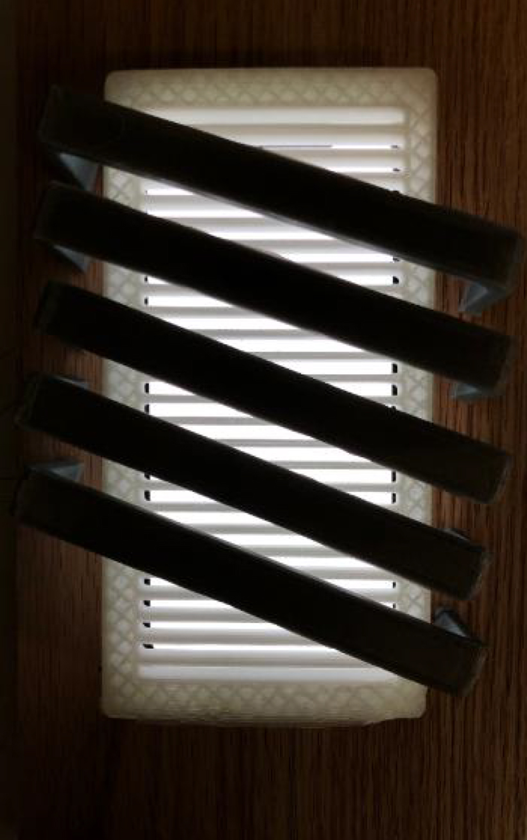 Light fixture with diagonal lines covering it