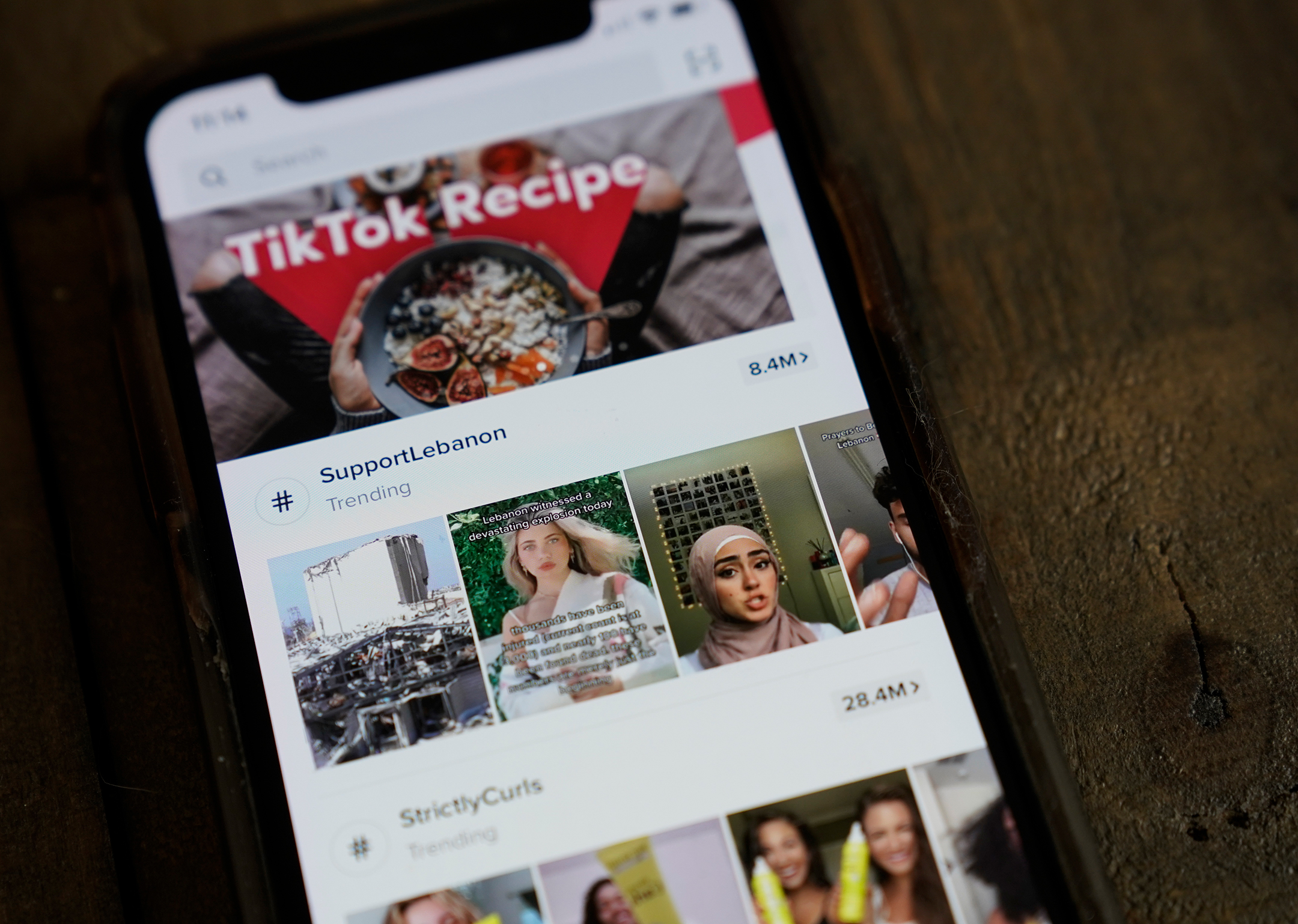 Photo of an iPhone screen showing the app homepage of TikTok