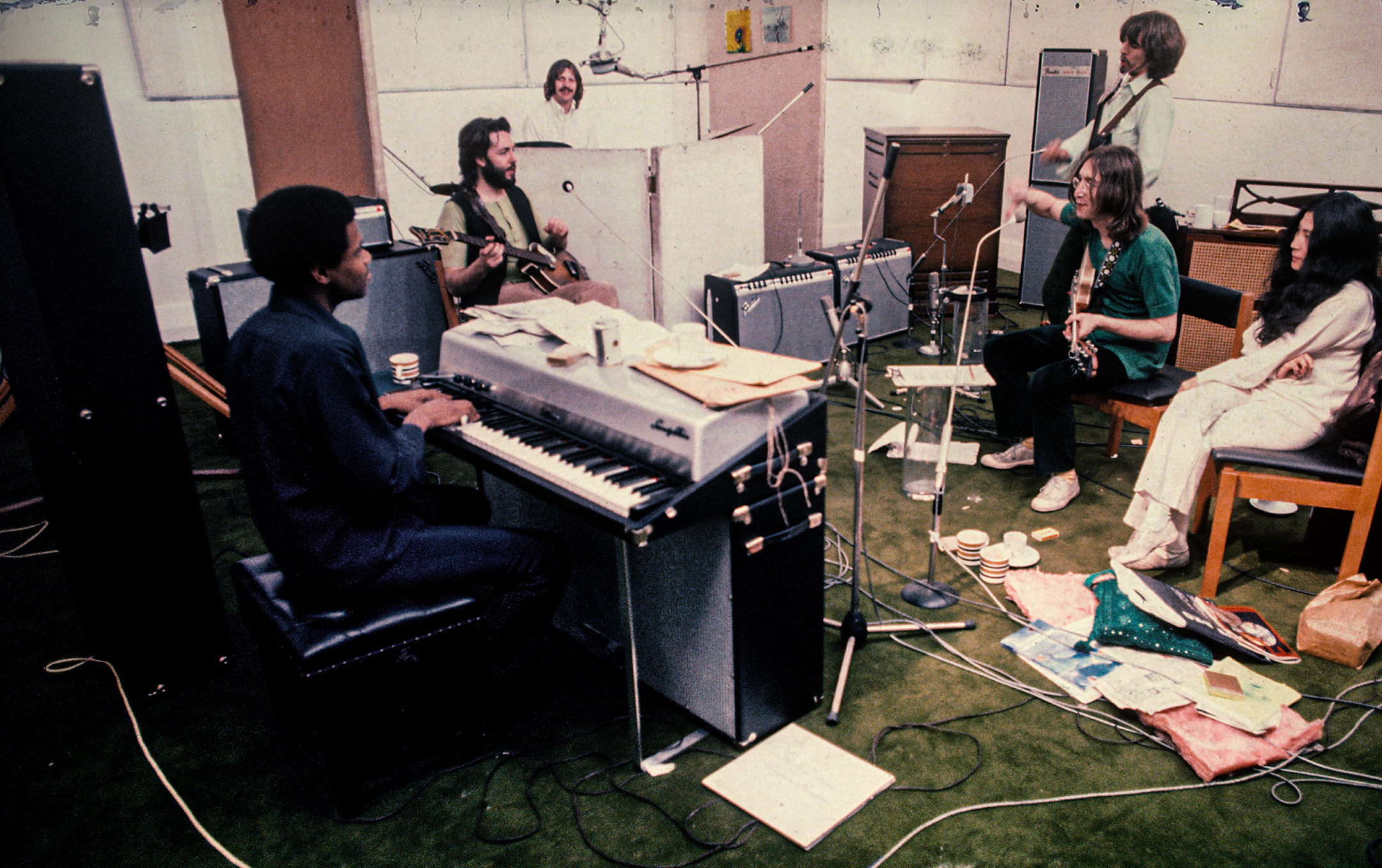 The Beatles, plus Billy Preston and Yoko Ono, in a rehearsal studio