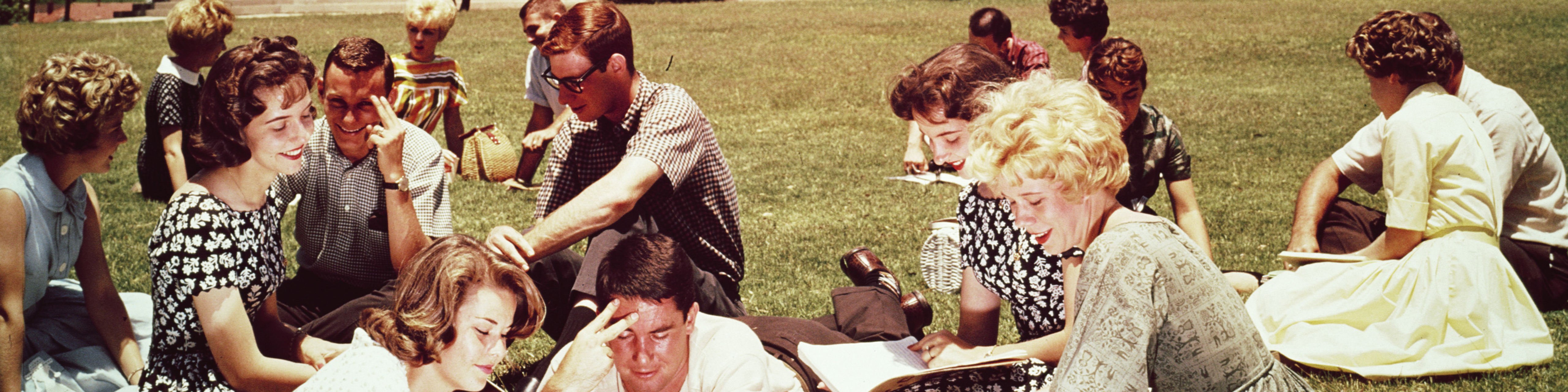 College students studying on the lawn on campus, 1970.