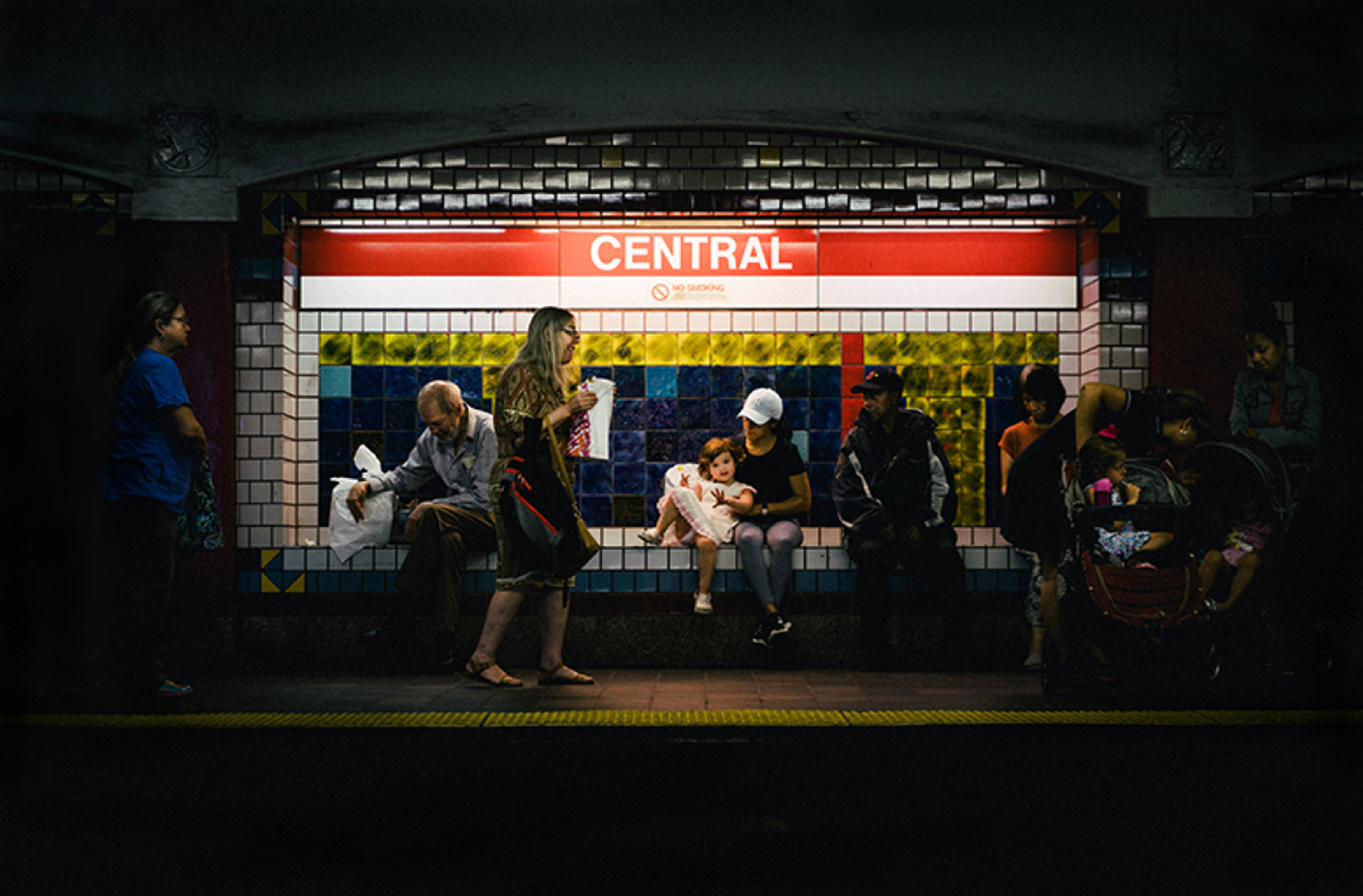 Photo of people sitting at a subway station