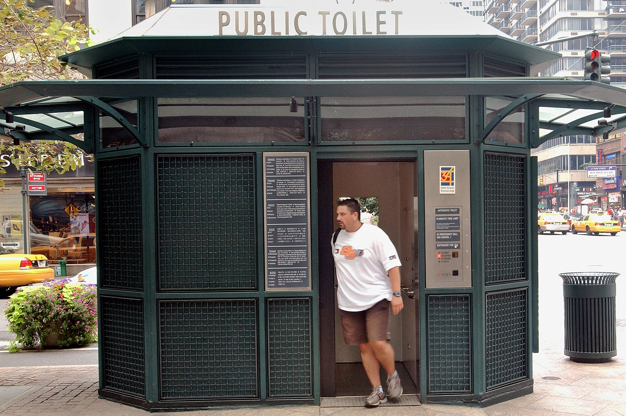 Photo of a man exiting a public bathroom in New York City