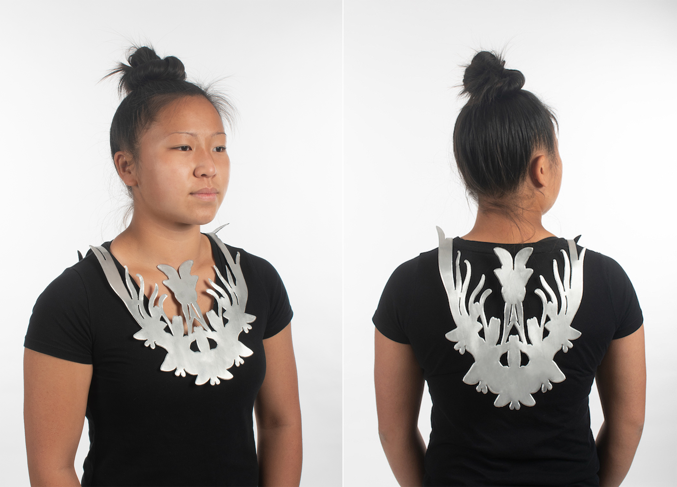 Photo of a young Asian woman with a heavy metal necklace in the shape of a winged animal