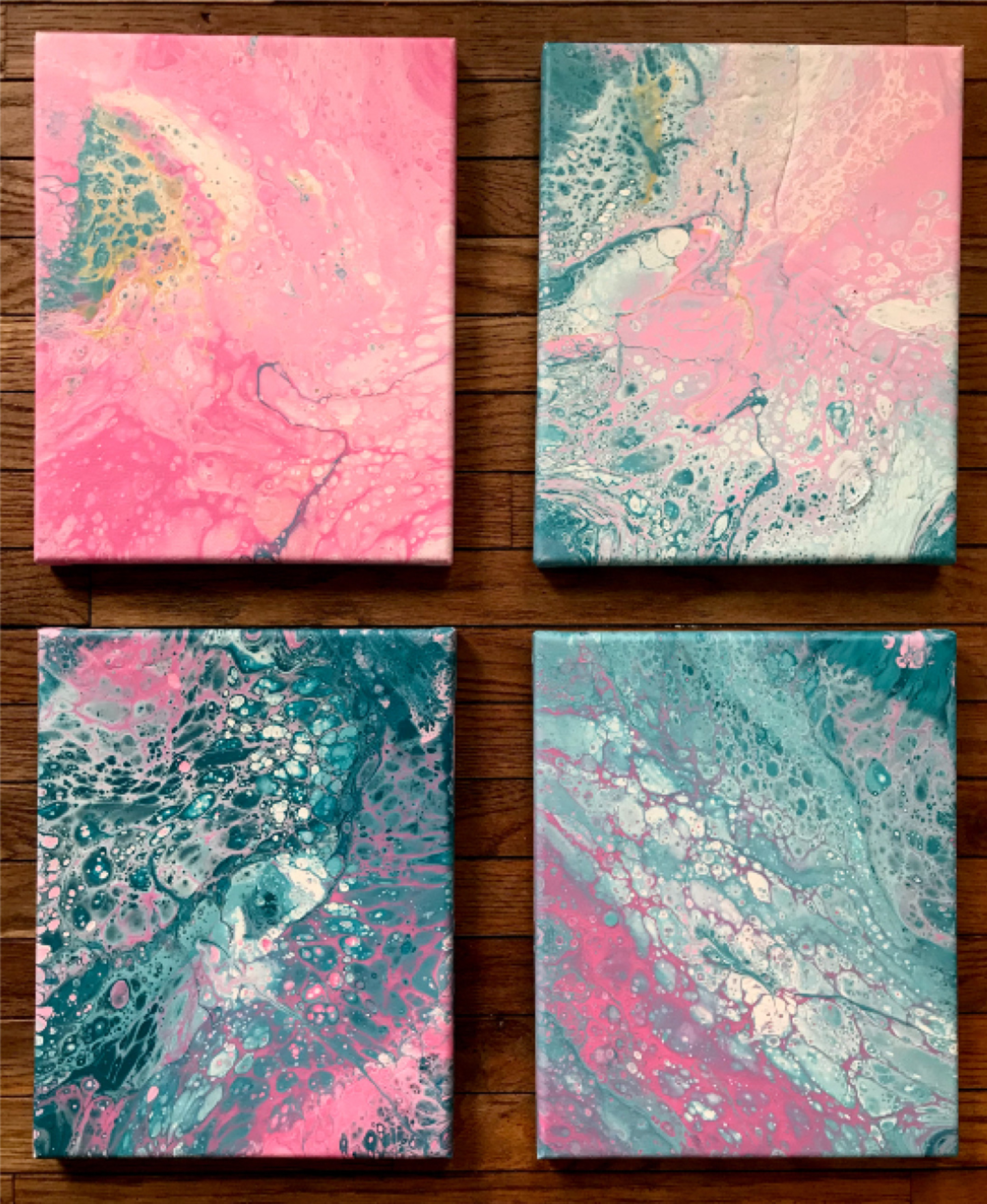 Four abstract paintings, two by two, in pink and turquoise