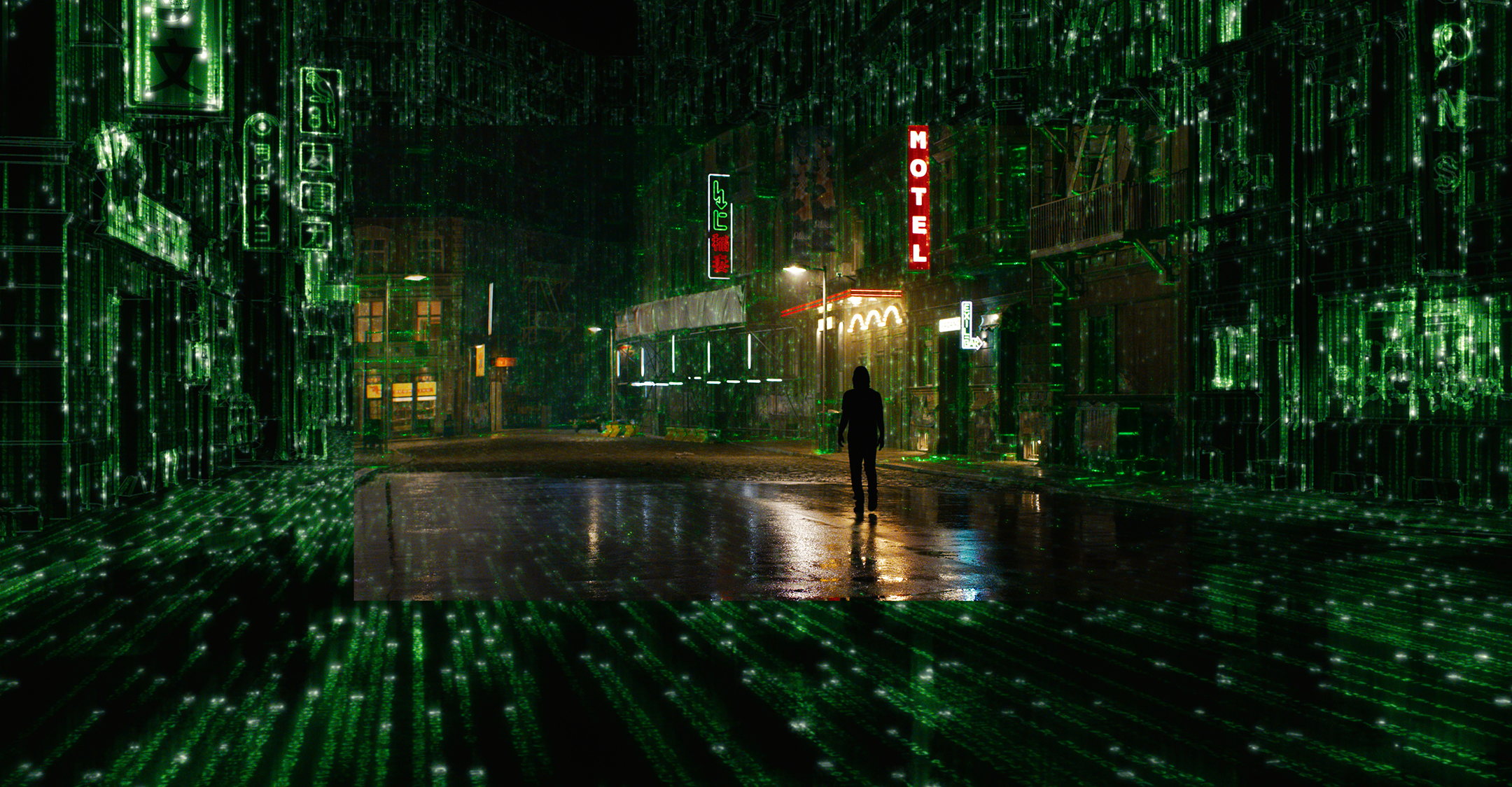 Still from The Matrix Resurrections depicting a man walking through a city street rendered in green computer code