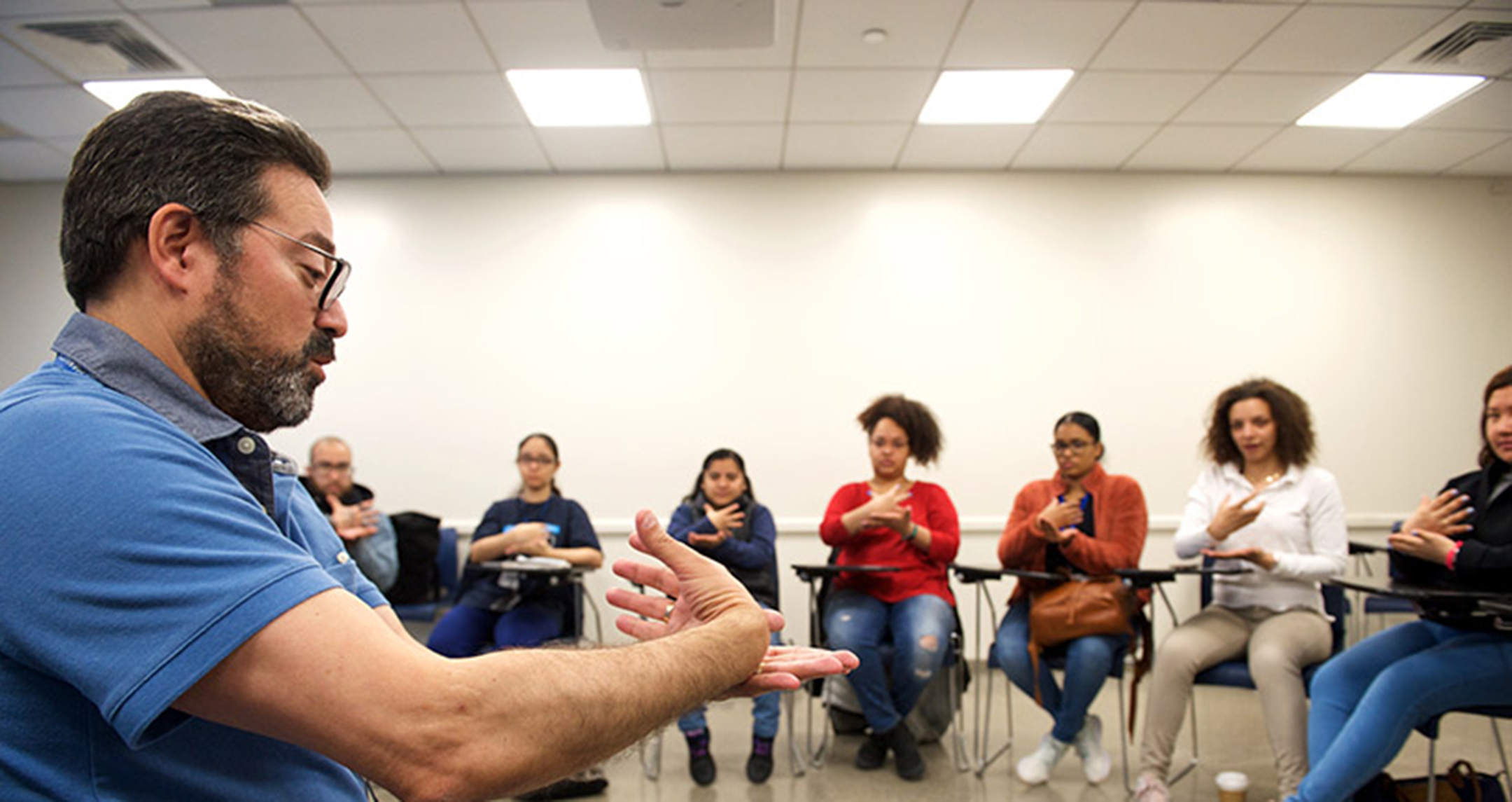 Teacher leading a sign language class