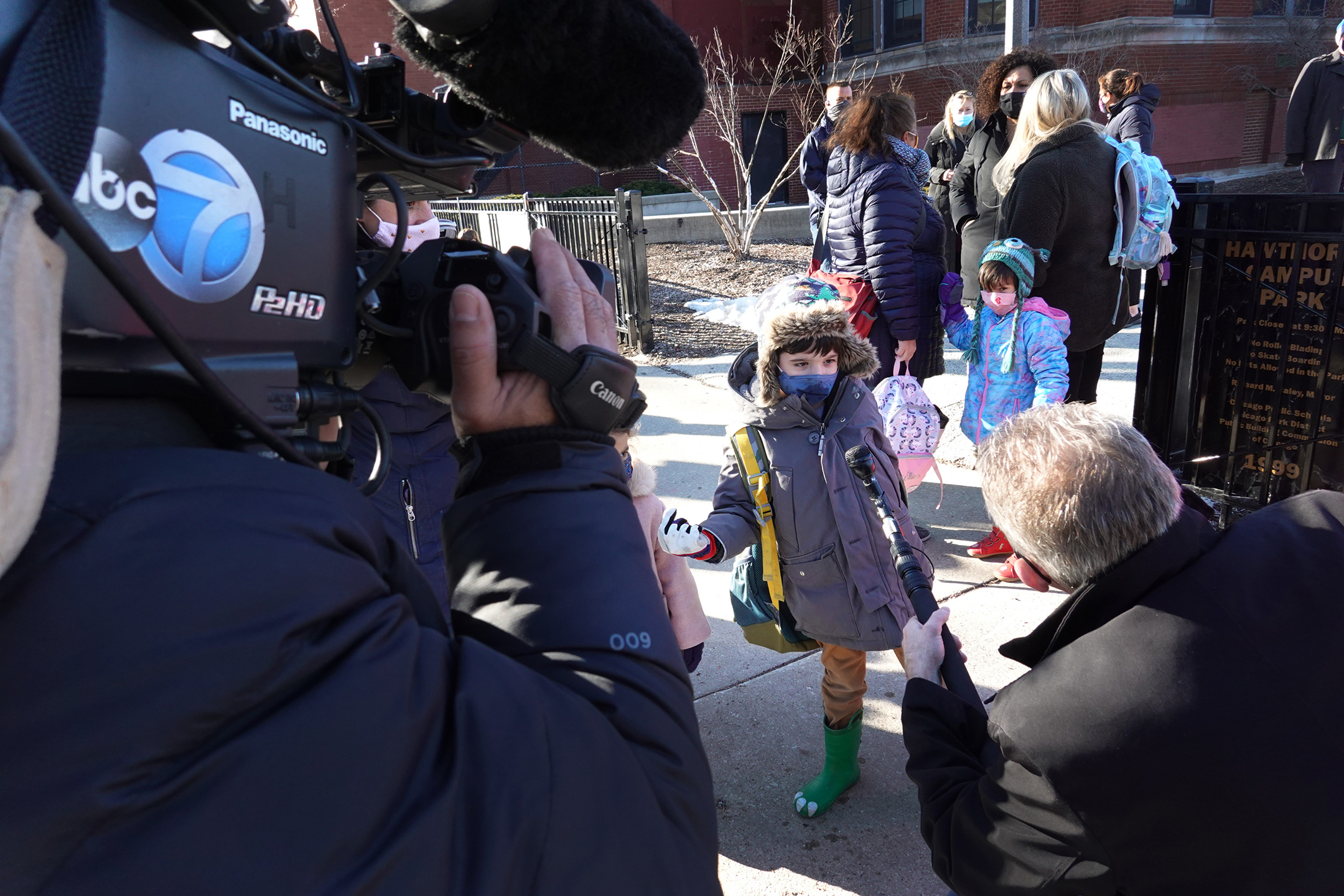 Children are interviewed by a television news reporter