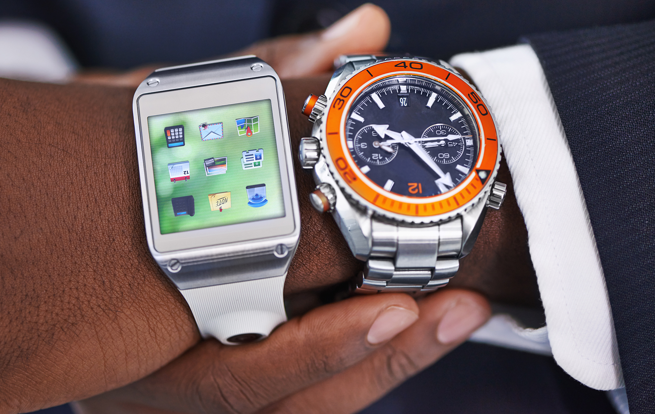 Cropped view of a young businessman wearing a smartwatch and a traditional watch 