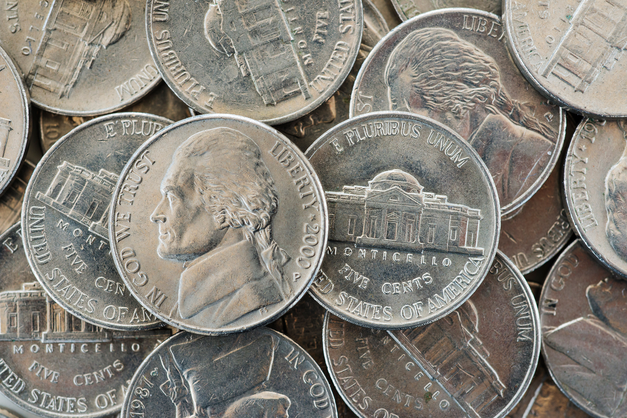 Closeup photo of a pile of American nickels