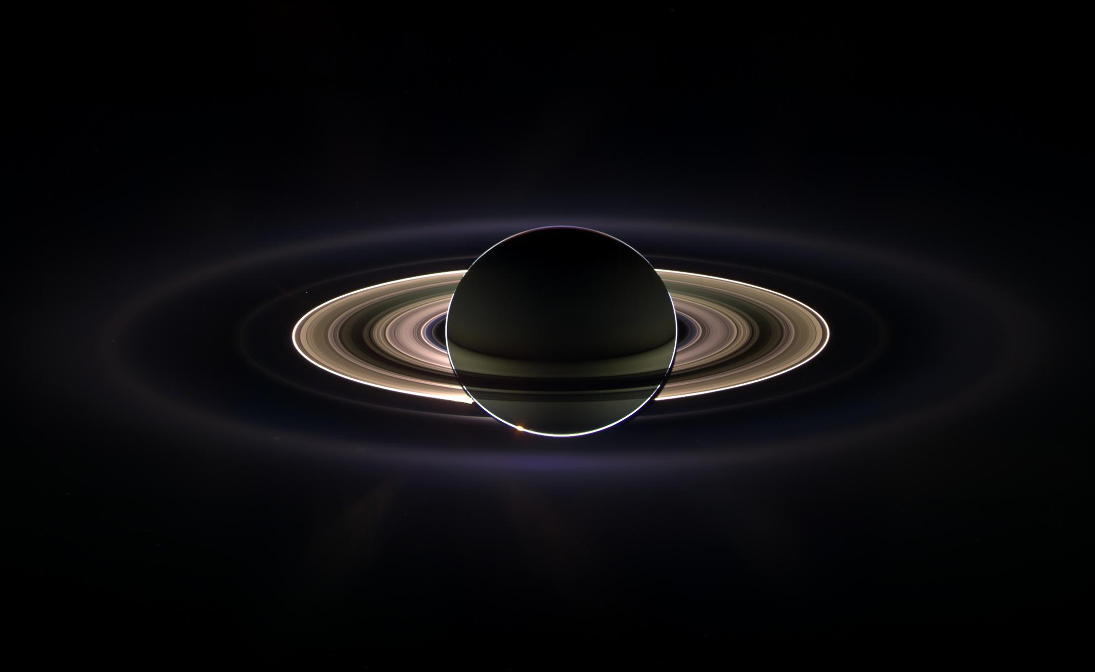 Image of Saturn and its rings in shadow and outlined against a black background