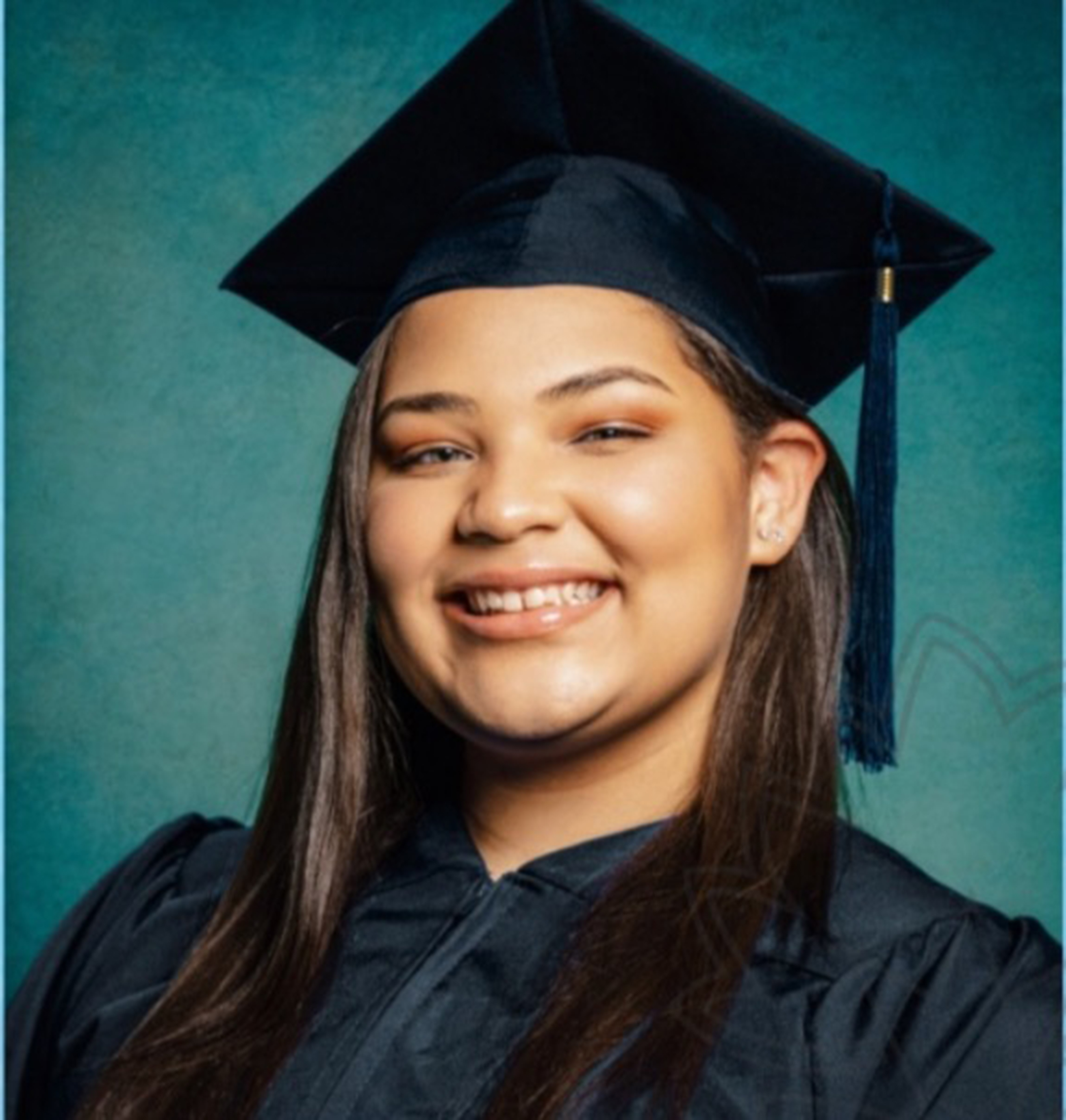 Headshot photo of Teanna Williams smiling in a graduation cap and gown against a green background