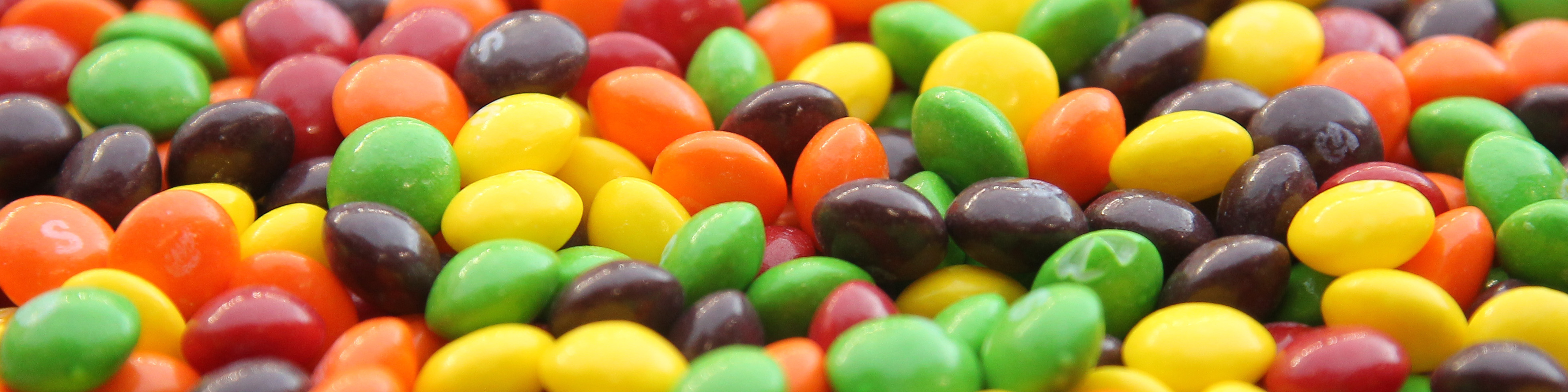 A closeup of a bowl of Skittles