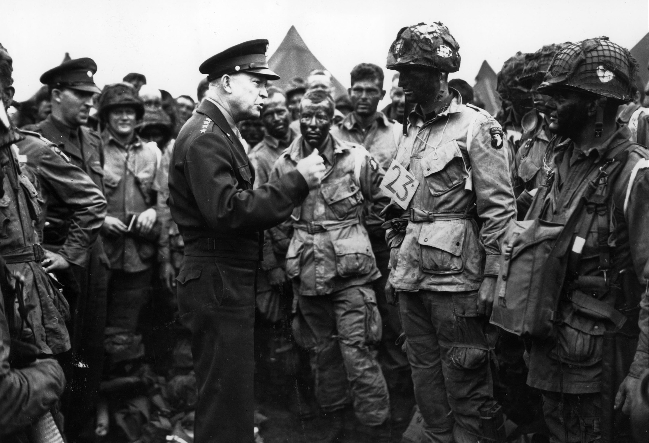 Black and white photo of a general talking to a group of soldiers