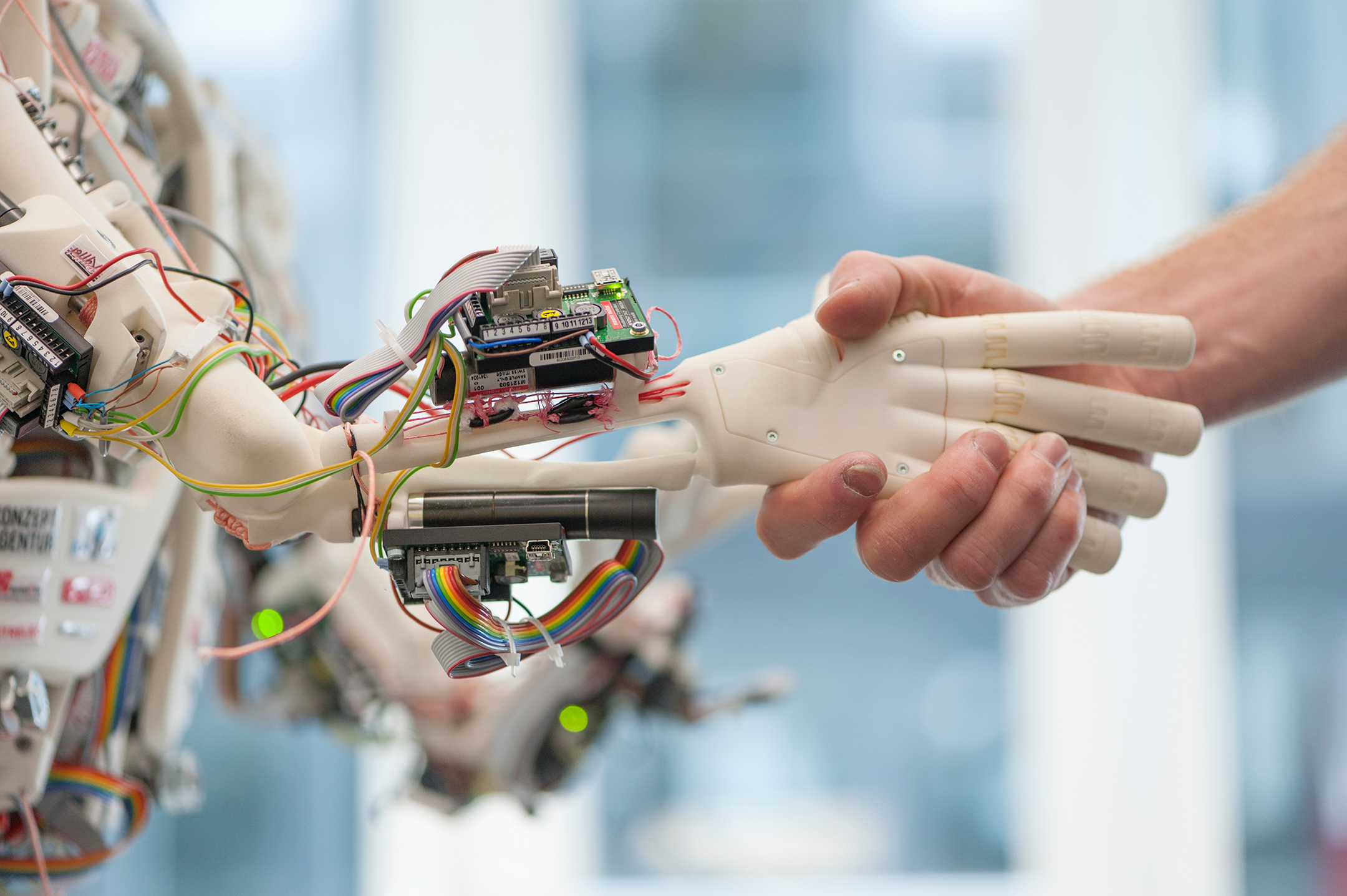 Human hand shaking a robot hand