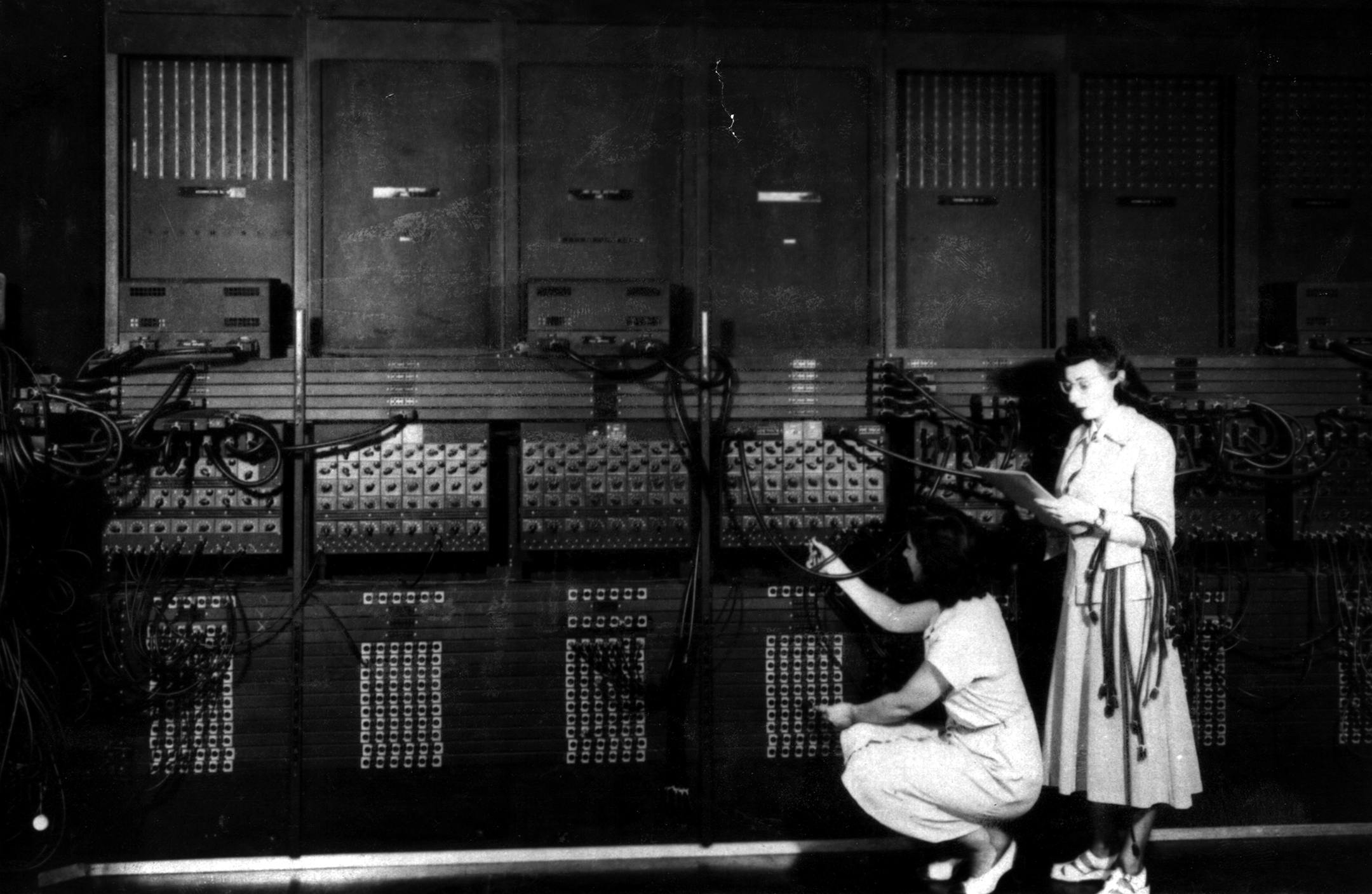 Two women working on the ENIAC in black and white photo