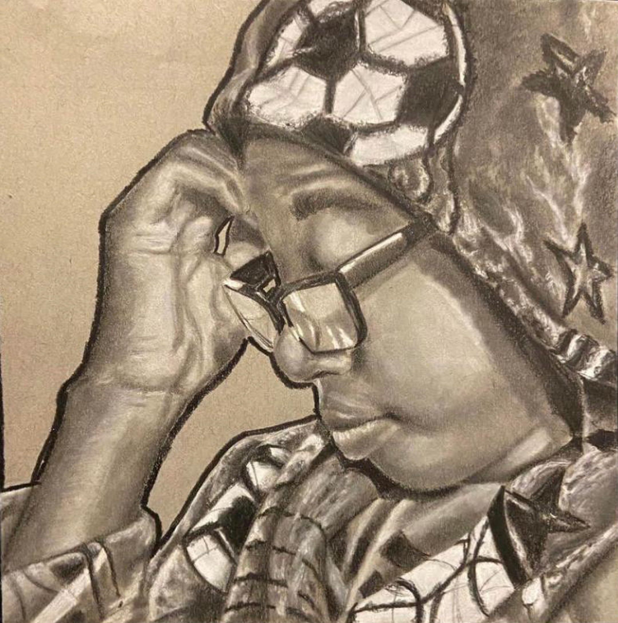 Black and white portrait of a young black man in glasses wearing a hooded robe with soccer balls and stars on it