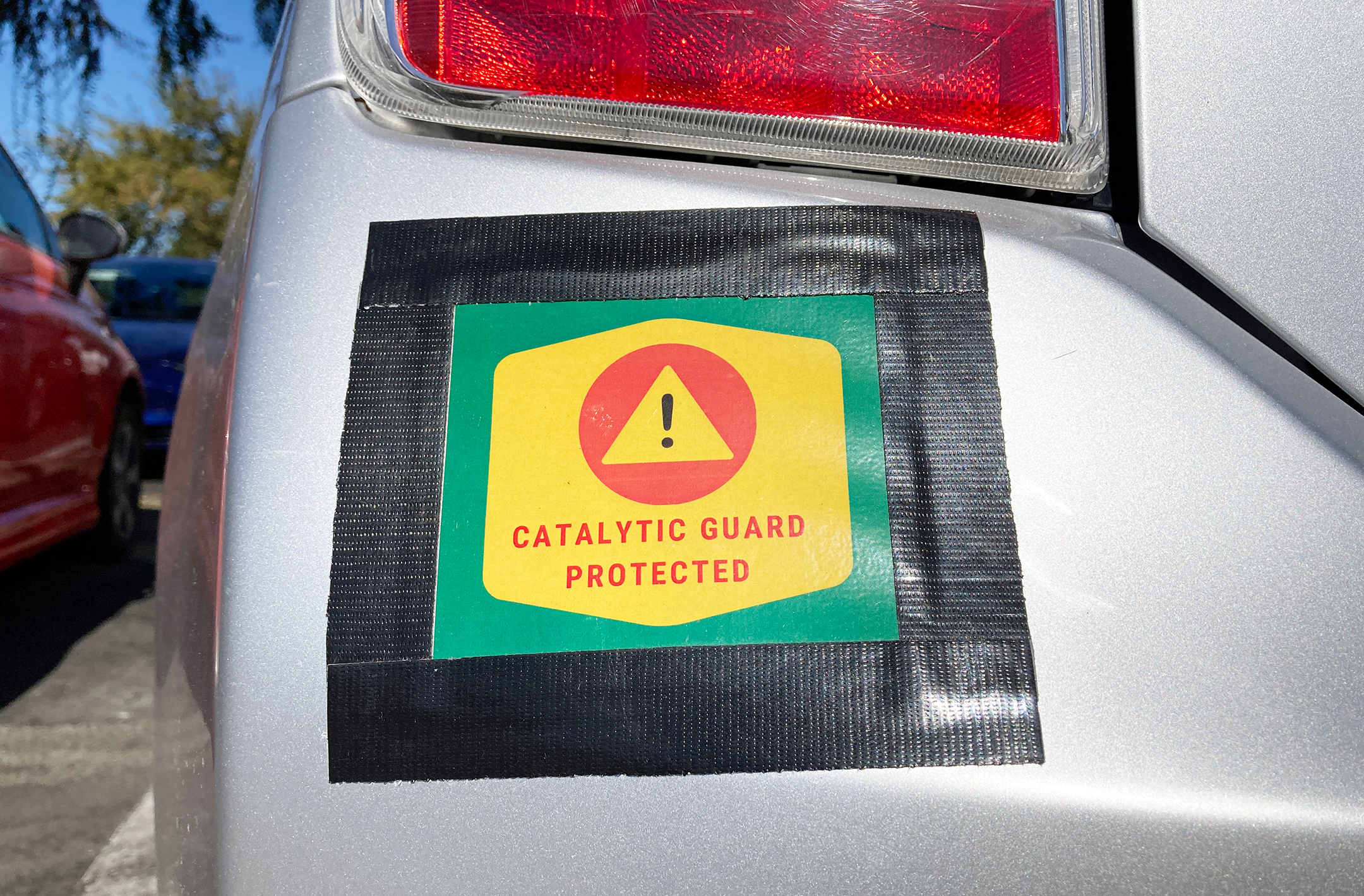 Catalytic Guard Protected sign on vehicle bumper
