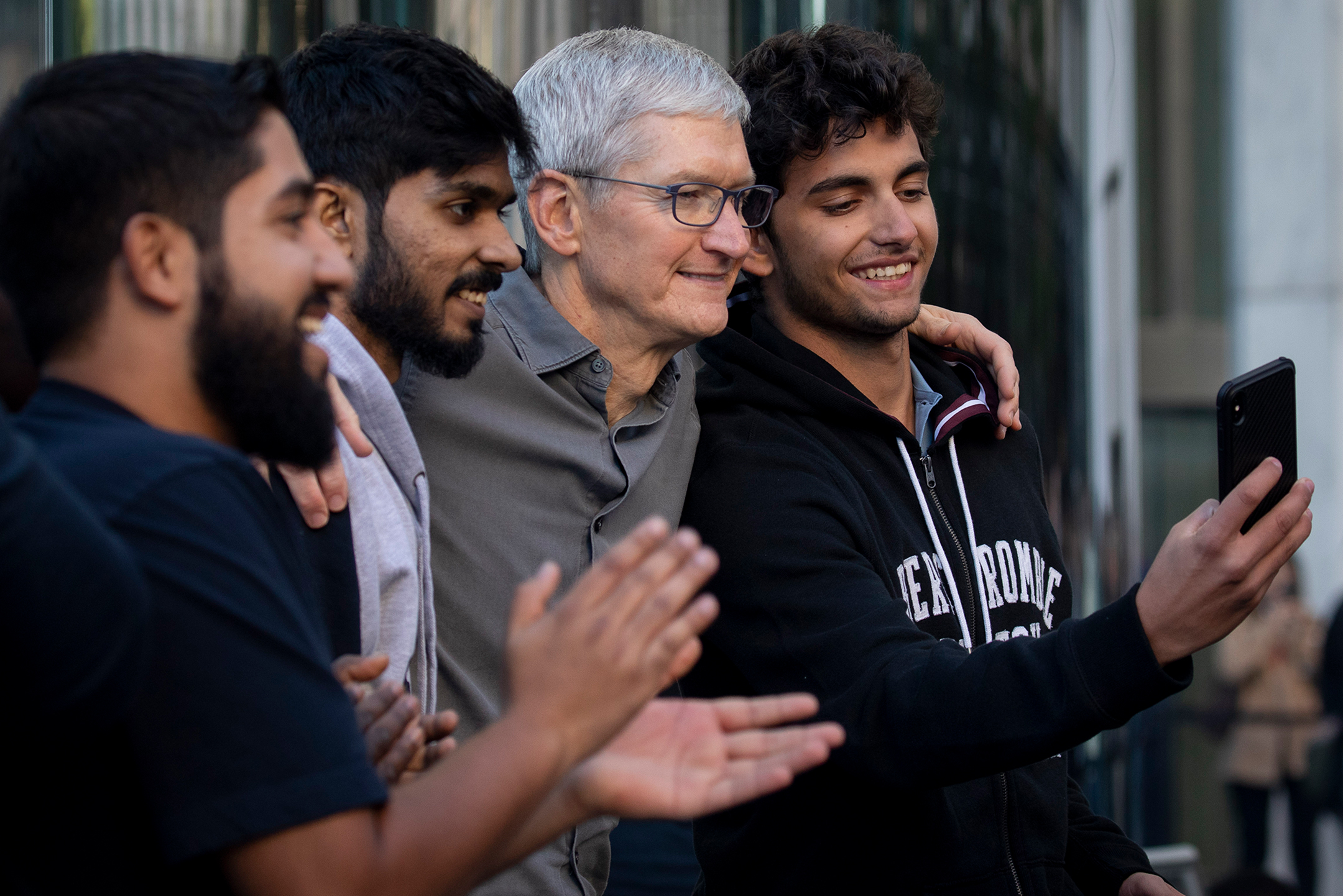 Group of people smiling and taking a selfie